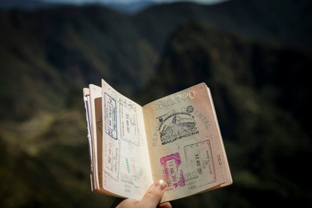 A person holding a passport, representing visa and travel documentation