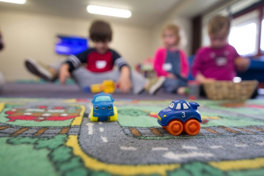 Young children playing with toys together on the floor