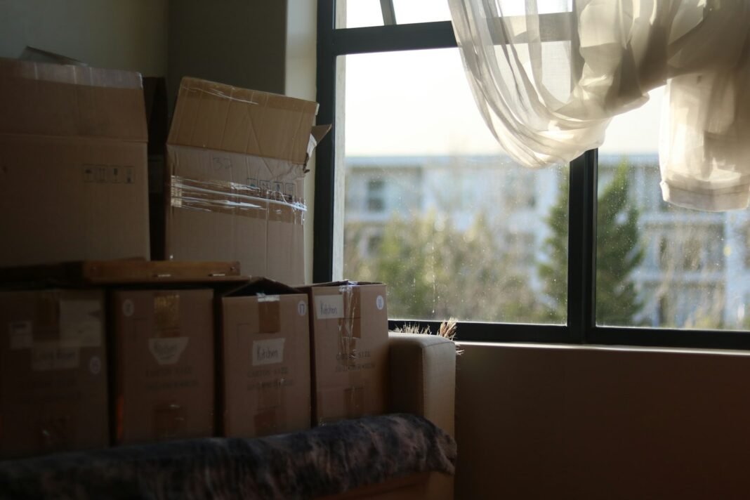 A room filled with packed moving boxes during a family relocation