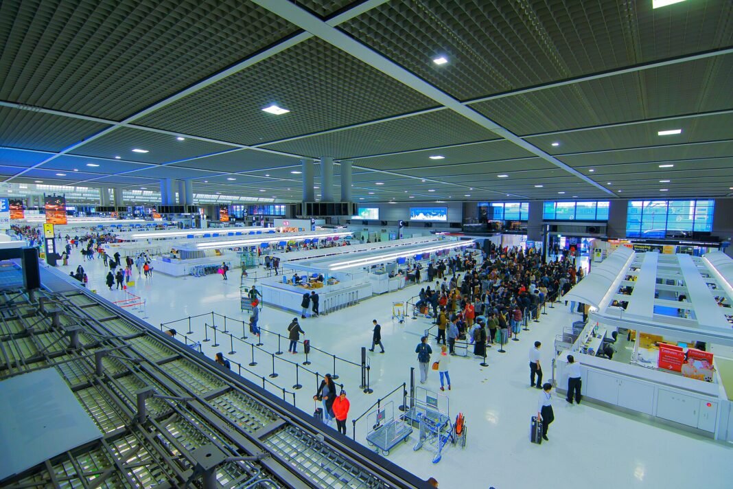 The departure lobby at Narita Airport Terminal 2 with travellers at check-in counters