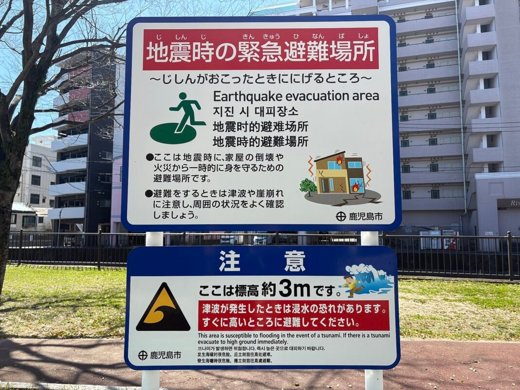 A bilingual Japanese and English sign marking an earthquake evacuation area